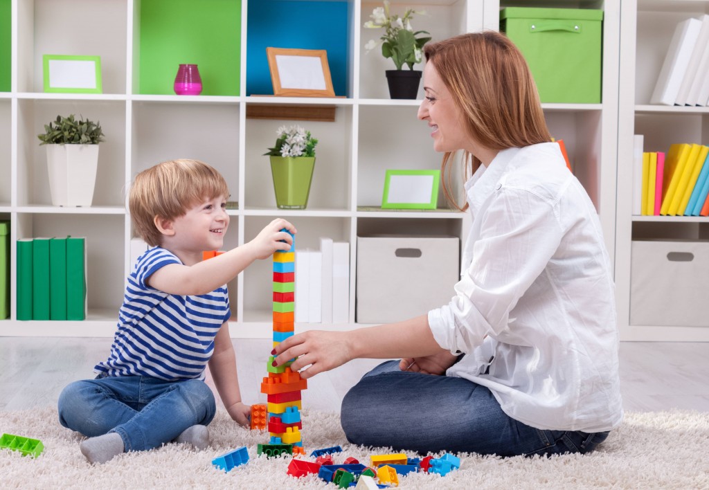 A Woman Playing Blocks With a Child