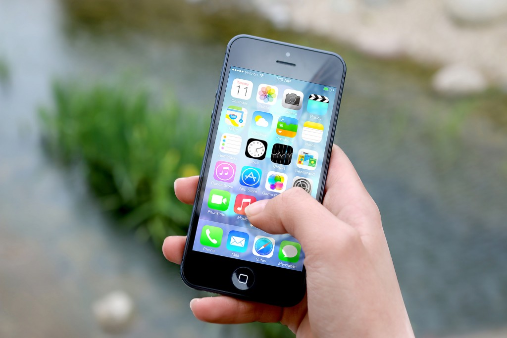 A Woman Holding an Apple Phone in Hand